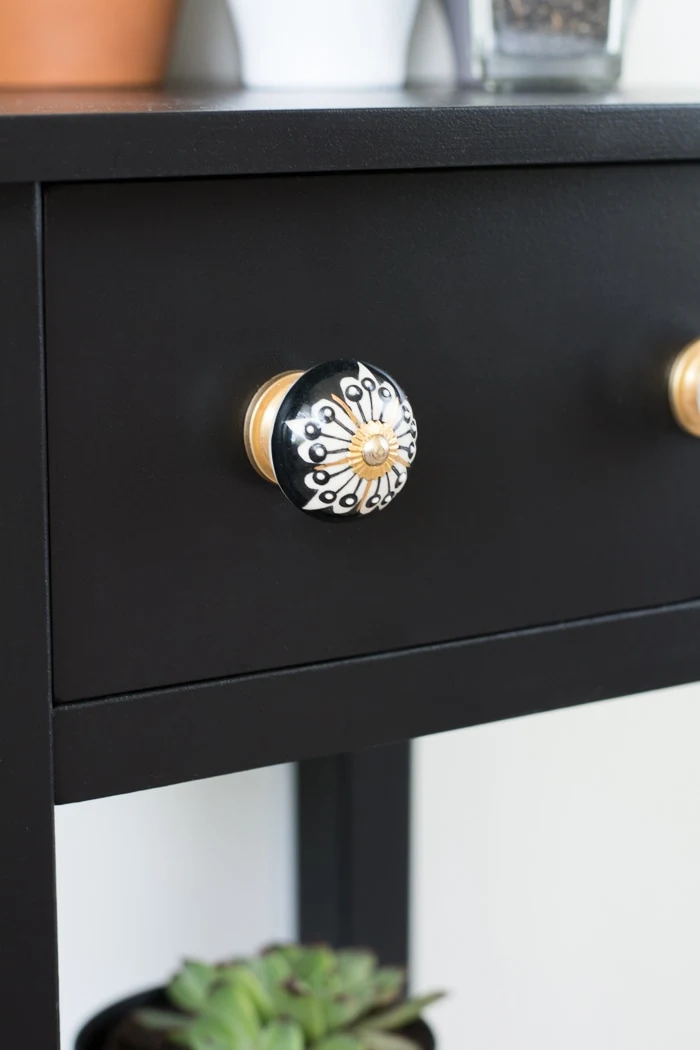 decorative knobs on a black nightstand