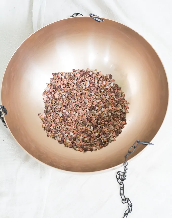 Adding pebbles to a planter to create a drainage layer