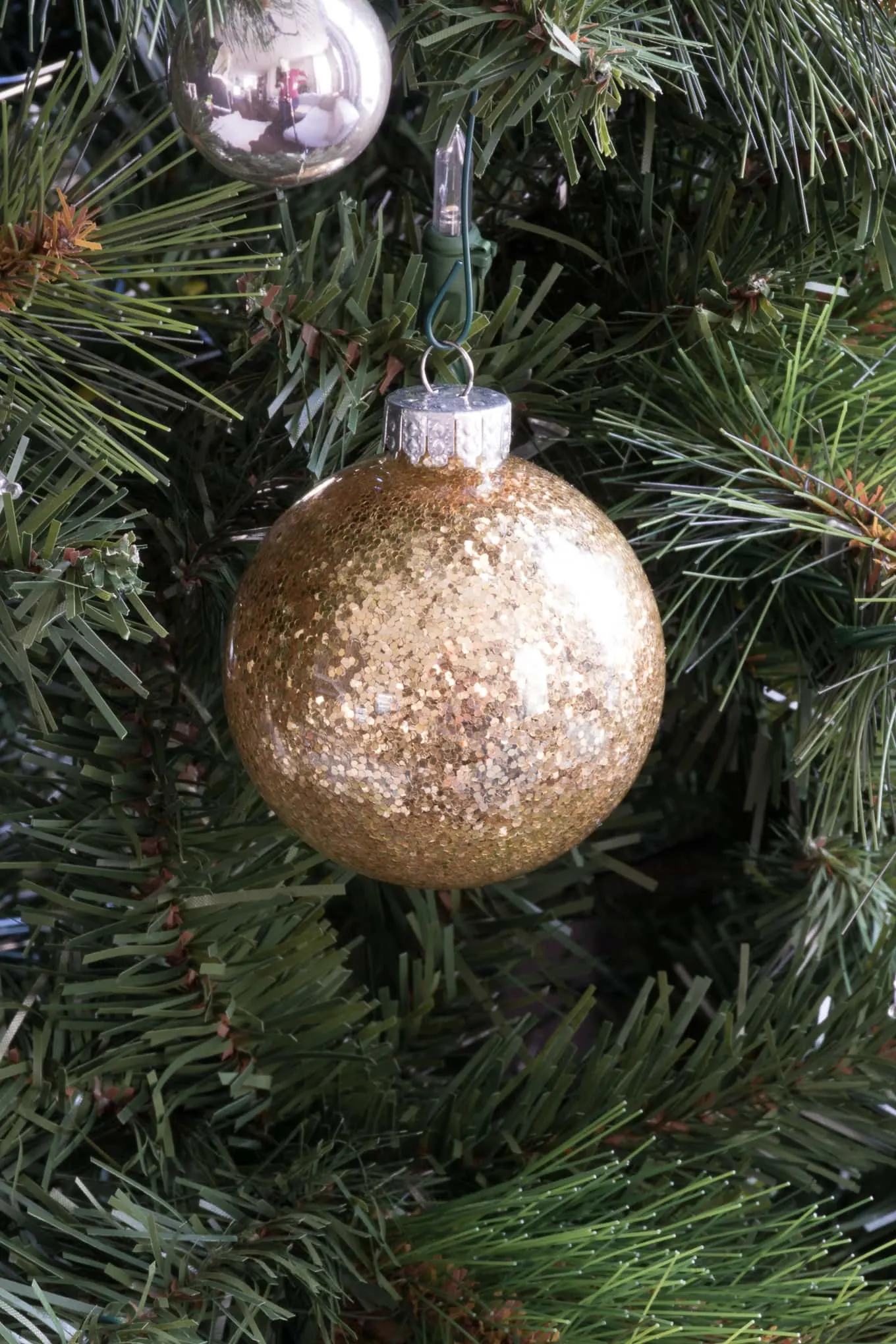 gold glittery ornament on a Christmas tree