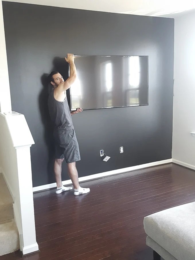 hanging a TV on a black living room wall
