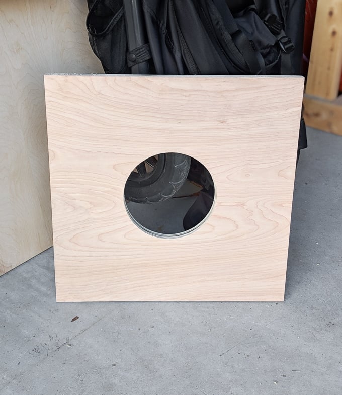 a piece of plywood with a hole cut in it