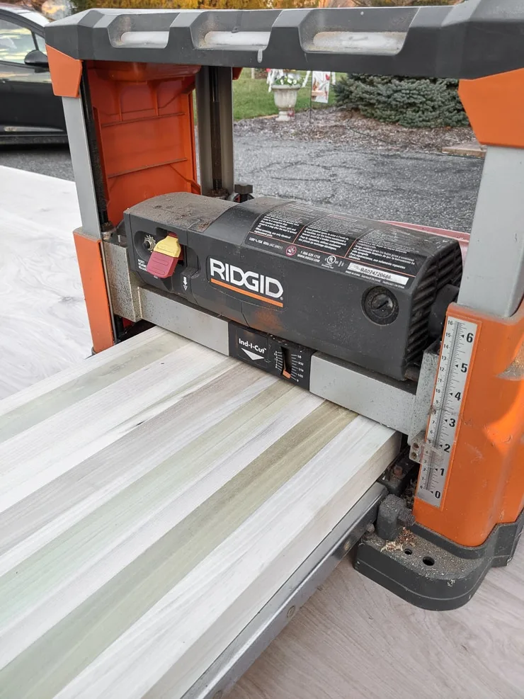 running wood planks through a planer