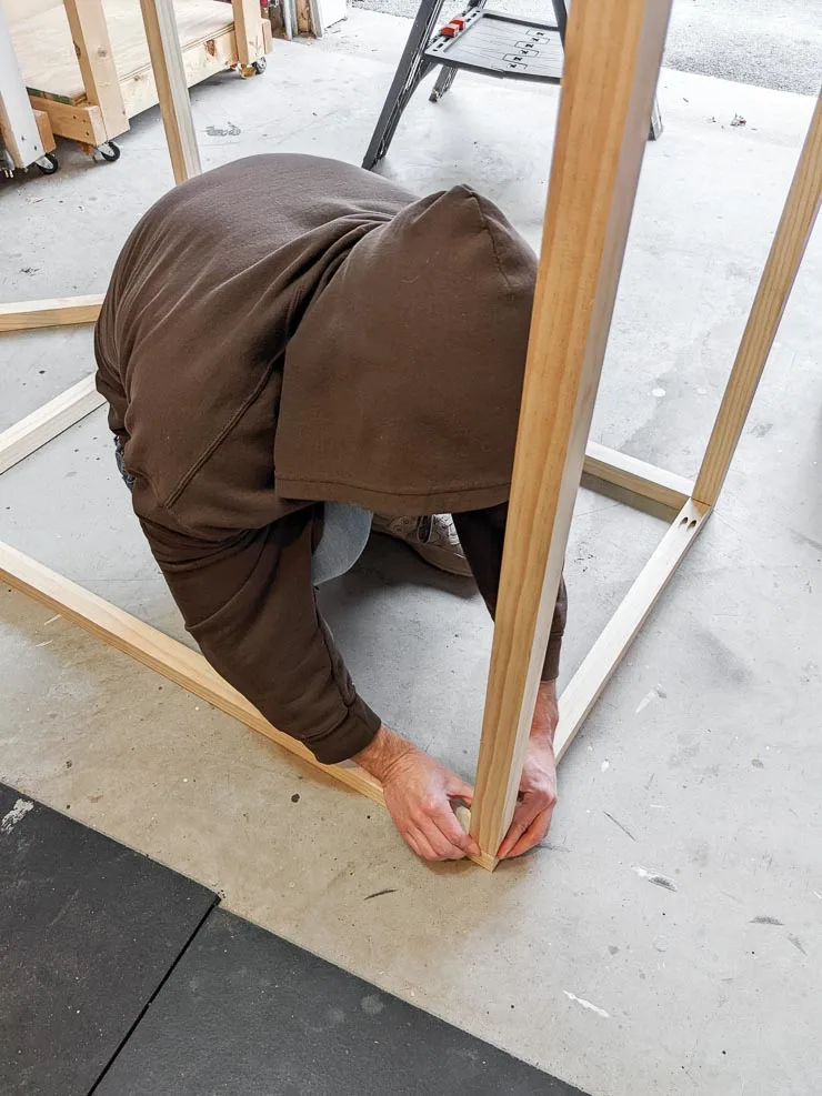 man holding a piece of wood in place