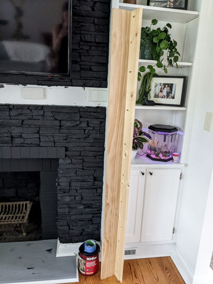 See how our modern DIY fireplace mantel shelf updated our living space!
