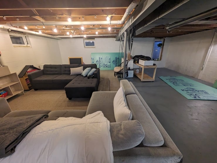 unfinished basement with couches and toys