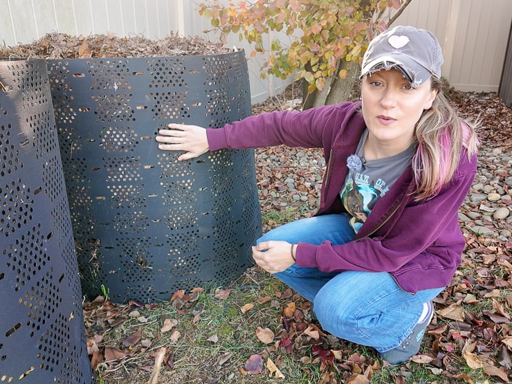 woman next to a compost bin